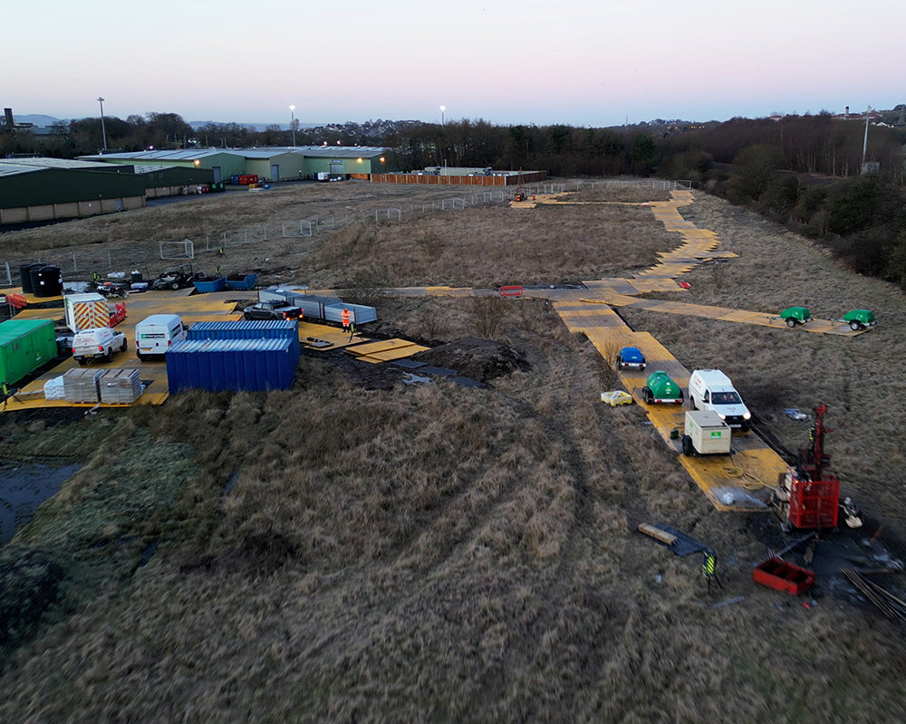 Aerial view of a construction site with various vehicles and equipment.