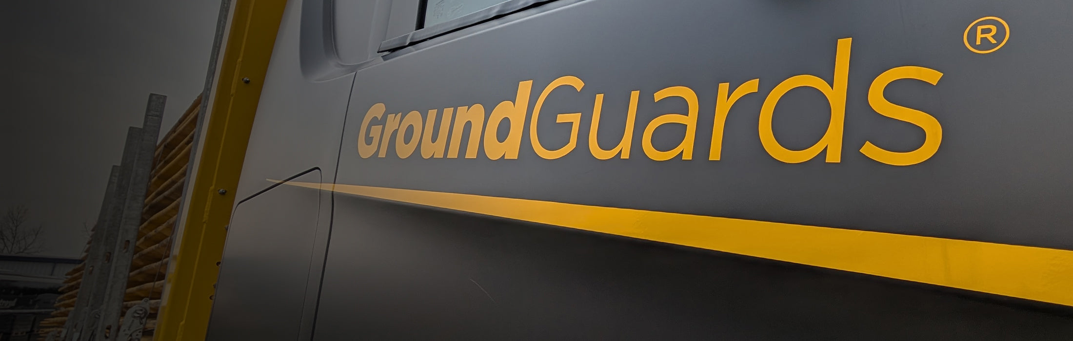 Close-up of a vehicle with 'GroundGuards' branding on a dark background