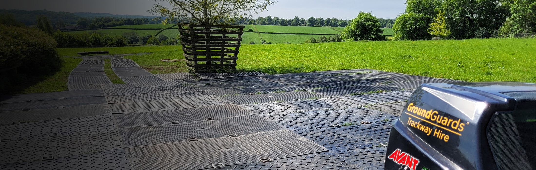 Ground protection mats being used for trackway in a grassy field