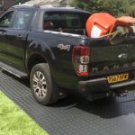 Temporary ground grass turf protection for builders truck