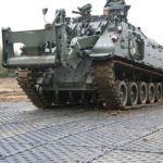 Tank driving over temporary roadway